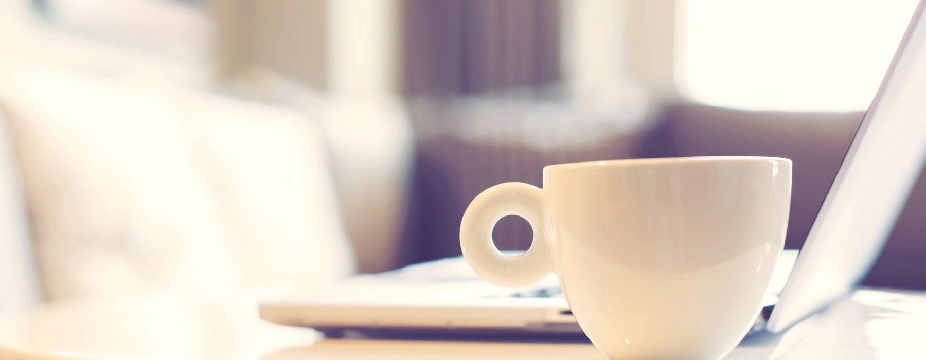 mug and laptop on table