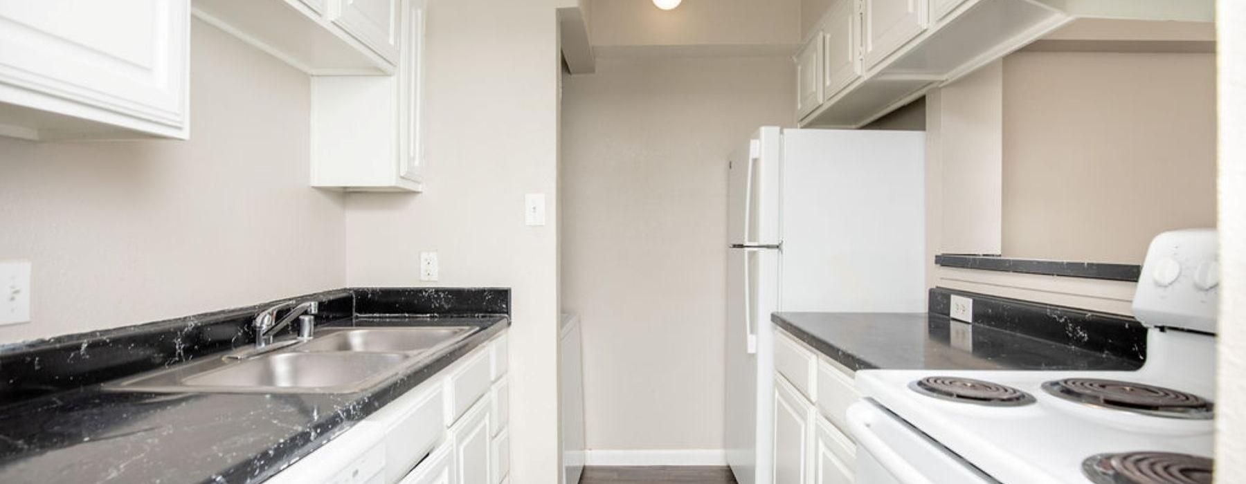 a kitchen with white cabinets