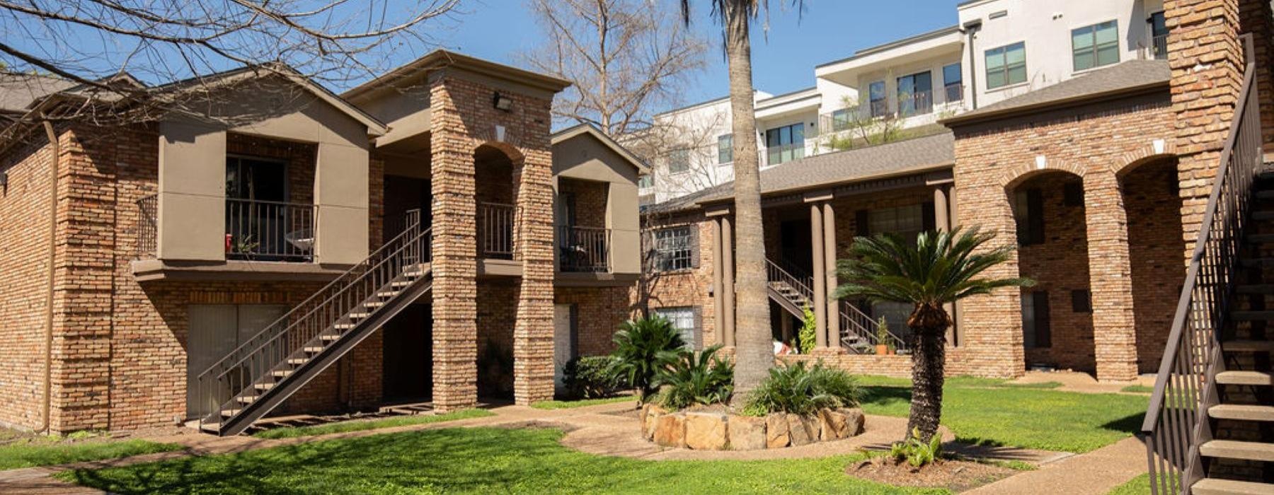 a building with a staircase and palm trees