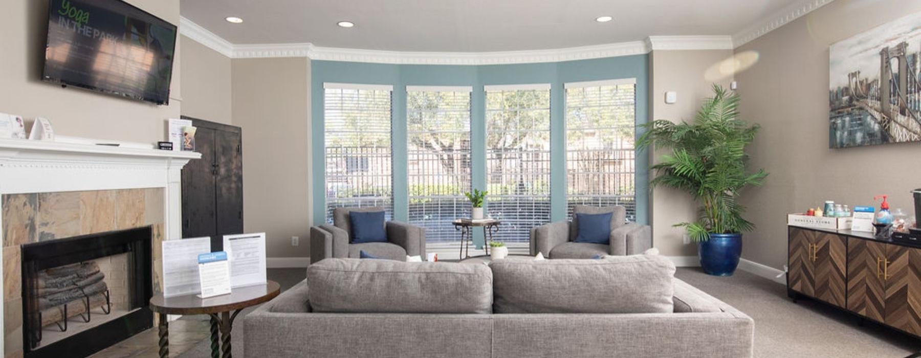 a living room with a fireplace and a large window