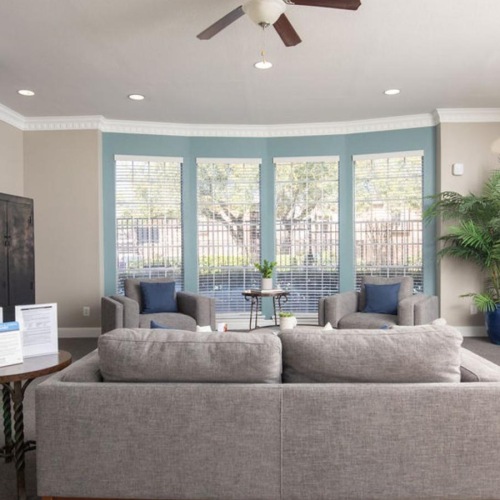 a living room with a fireplace and a large window