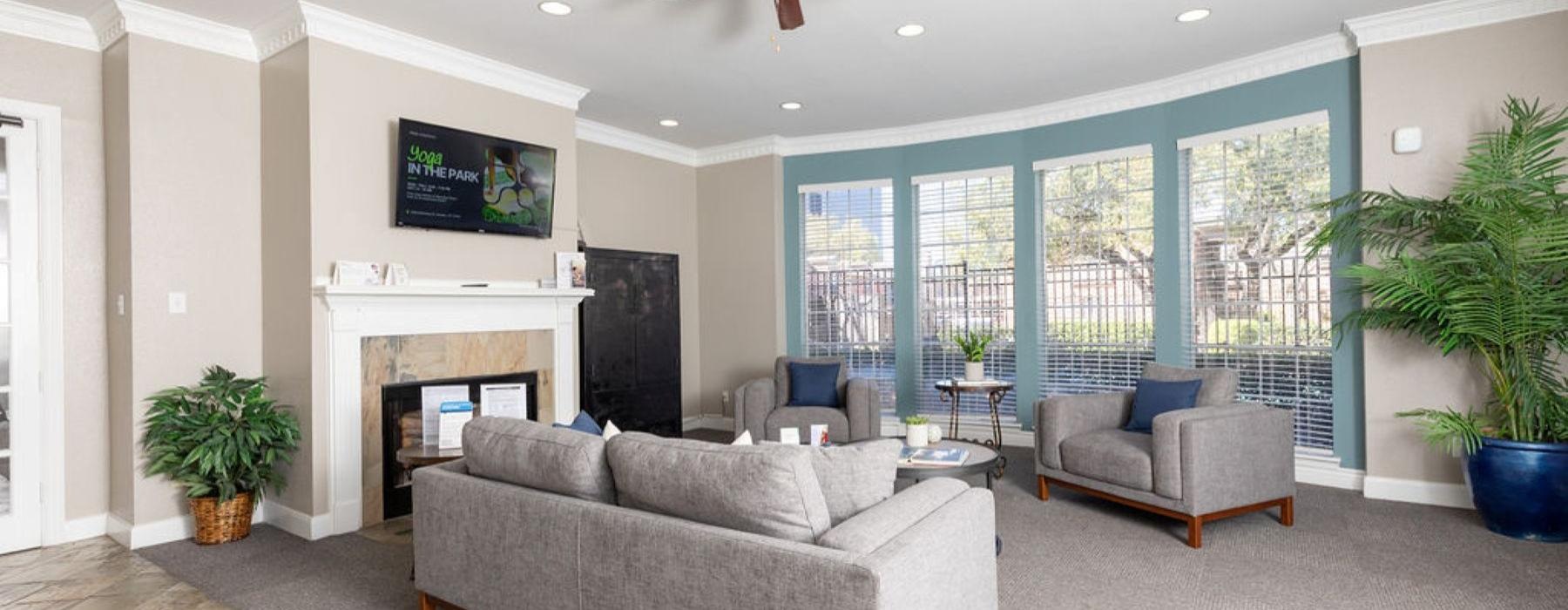 a living room with a fireplace and a tv