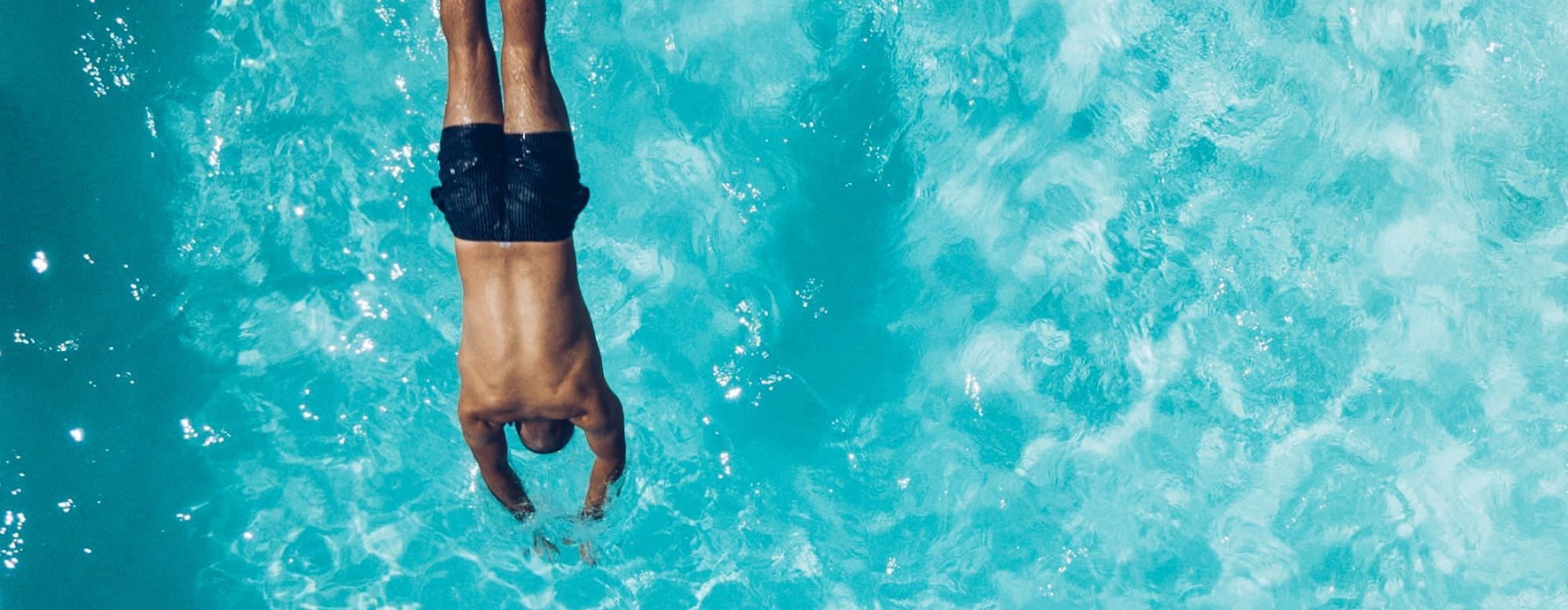 a man diving into a pool